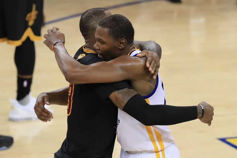Kevin Durant of the Golden State Warriors hugs LeBron James (left) of the Cleveland Cavaliers after defeating the Cleveland Cavaliers 129-120 in Game 5 to win the 2017 NBA Finals at the Oracle Arena in Oakland, Calif., on June 12, 2017. (Ronald Martinez/Getty Images)